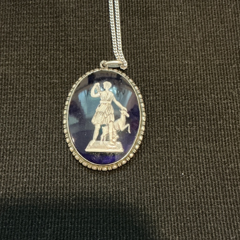 Silver Pendant Necklace on Blue Glass